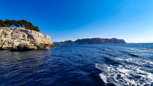 Scenic view of sea against clear blue sky