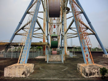 Ferris wheel in amusement park against clear sky