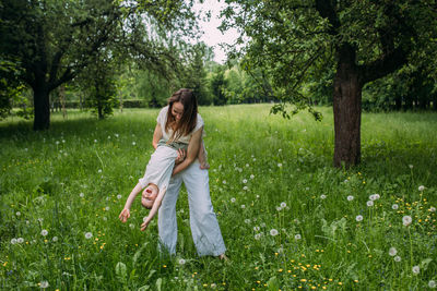 Side view of young woman standing on field