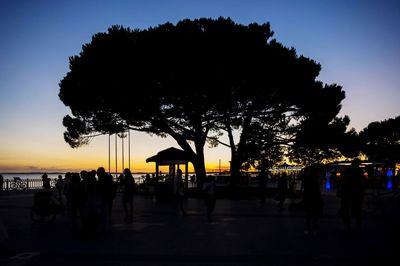 Silhouette people at beach during sunset