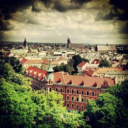 Buildings against cloudy sky