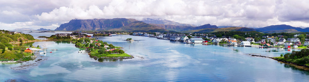 Panoramic view of sea and bronnoysund against cloudy sky