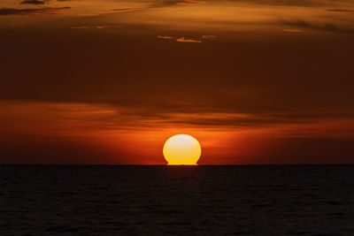 Scenic view of sea against orange sky