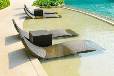 High angle view of chair by swimming pool