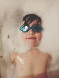 Portrait of shirtless boy in bathroom