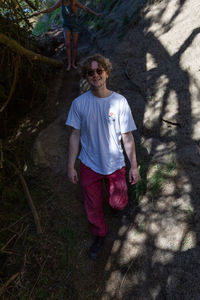 Portrait of man standing in sunlight