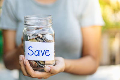 Close-up of woman hand holding jar