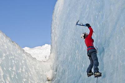 Woman climbing on the fjallsjökull glacier in iceland