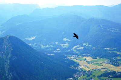 High angle view of airplane flying over mountains