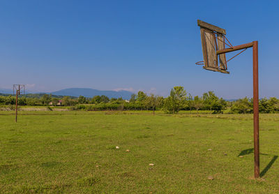 Wind turbines on field against clear sky