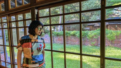 Woman standing by window