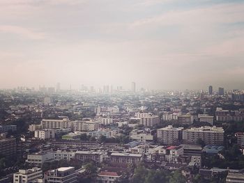 Aerial view of cityscape against sky