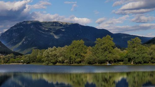 Scenic view of lake and mountains against sky