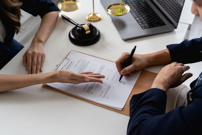 Midsection of businessman working on table