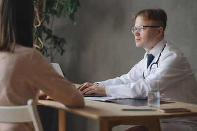 Midsection of doctor examining patient in hospital