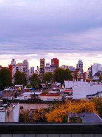 High angle view of city buildings against sky during sunset