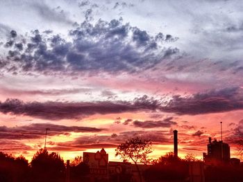 Silhouette city against sky during sunset