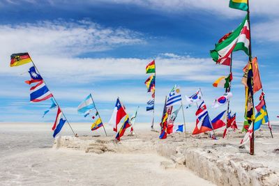 Waving flags of different countries at the entry of salar de uyunu, bolivia