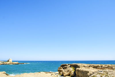 Scenic view of sea against clear blue sky