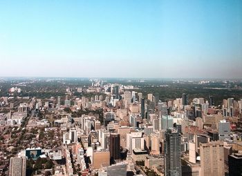 Aerial view of modern buildings in city against clear sky