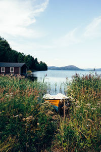 Scenic view of lake by building against sky