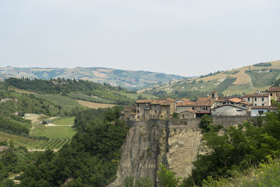 Scenic view of landscape and buildings against sky