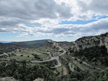 Scenic view of landscape against cloudy sky