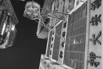 Low angle view of illuminated chandelier hanging in city