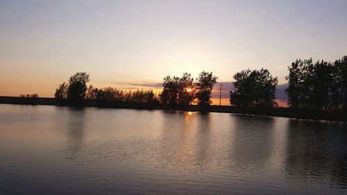 Scenic view of lake at sunset