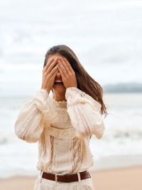 Young woman standing at beach