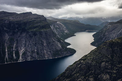 Aerial view of lake by mountain against sky