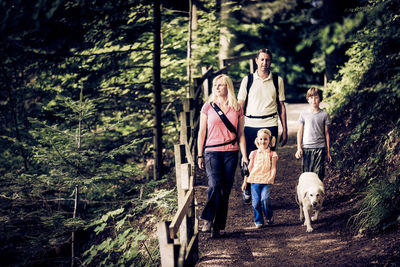 Father with dog walking in forest