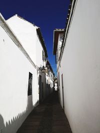 Street amidst buildings against clear sky