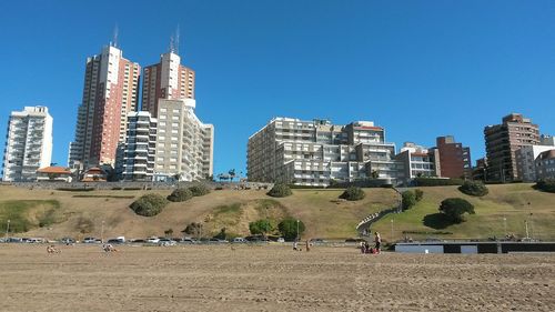 View of cityscape against clear blue sky