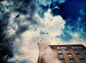 Low angle view of building against cloudy sky