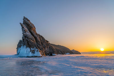 Scenic view of sea against clear sky during sunset