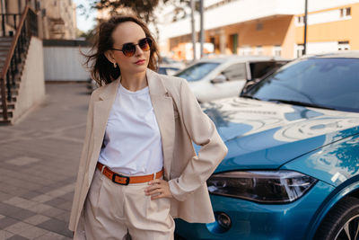 Young woman in white pantsuit and white t-shirt in city location