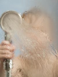 Cropped image of man swimming in water