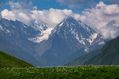 Scenic view of snowcapped mountains against sky