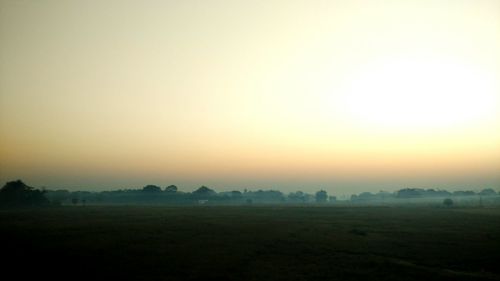 Scenic view of field against sky during sunset