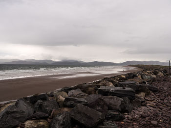 Rocks on beach against sky