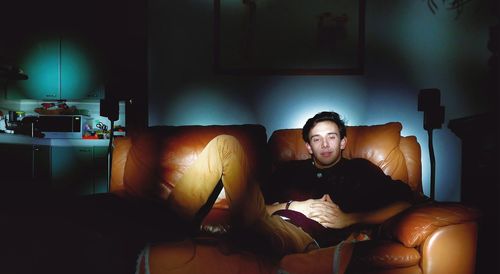 Man sitting on sofa at home