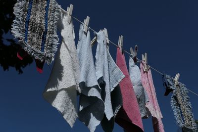 Low angle view of napkins and doormat drying on clothesline