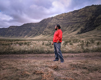 Rear view of man standing on mountain