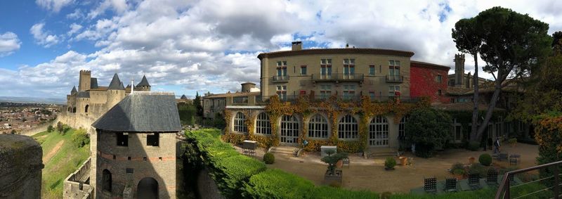 Panoramic view of buildings in city against sky