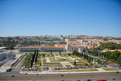 High angle view of buildings against clear blue sky