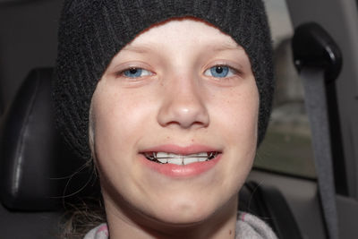 Close-up portrait of smiling young woman