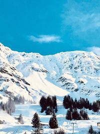 Scenic view of snow covered mountains against sky