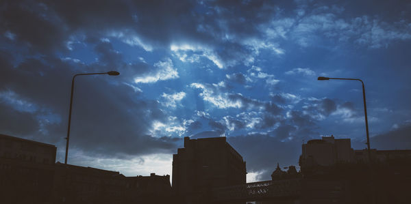 Low angle view of silhouette buildings against sky