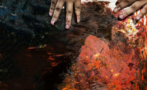 High angle view of hands touching water